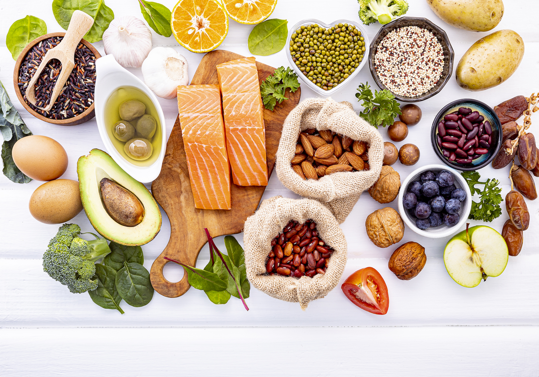 overhead view of a variety of healthy foods on white background
