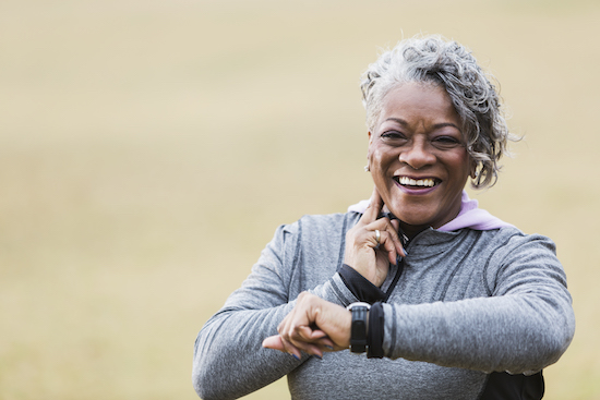 Woman Smiling Checking Heart Rate On Neck.jpg